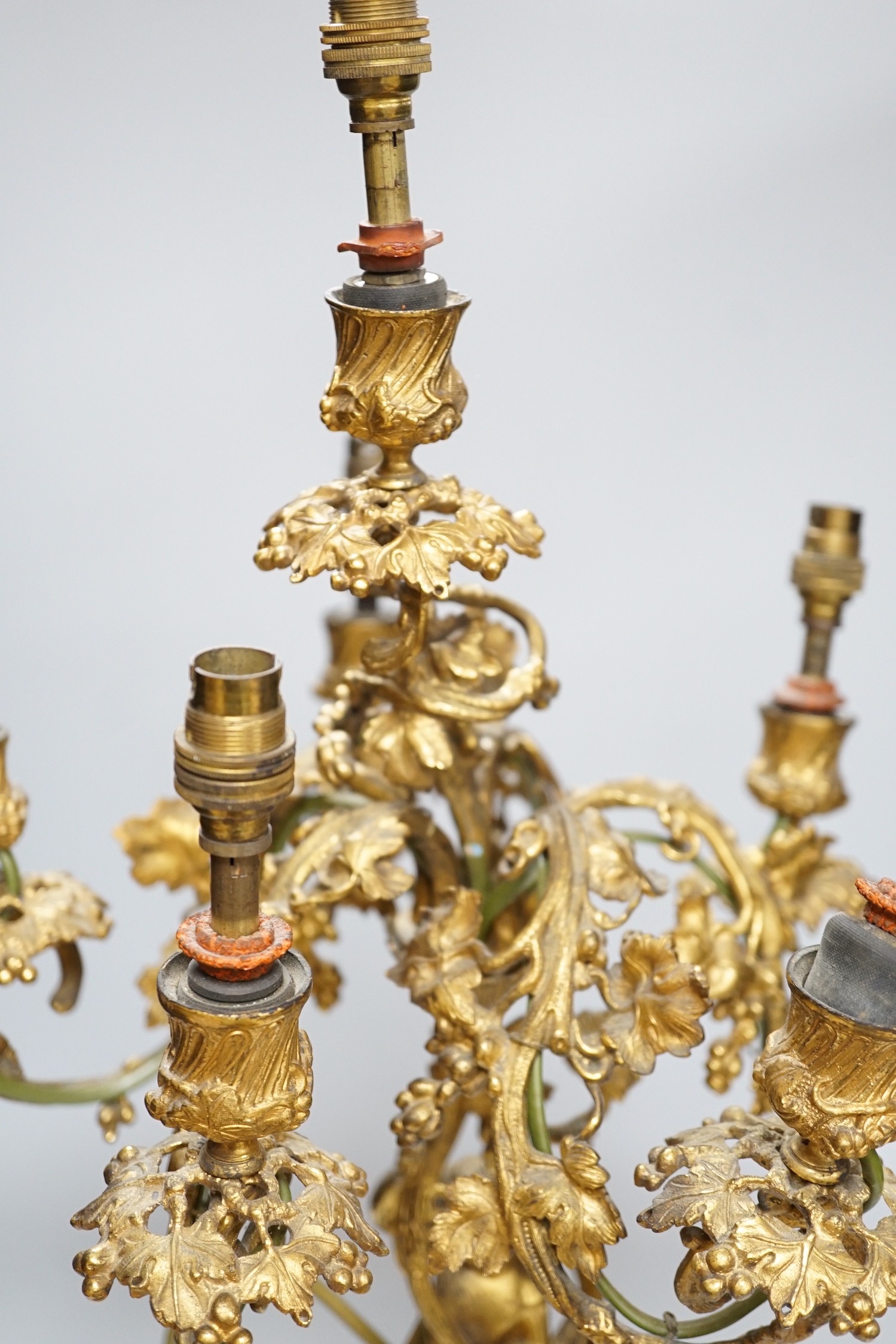 An ornate six branch ormolu cherub candelabrum, converted to a lamp, 54cms high